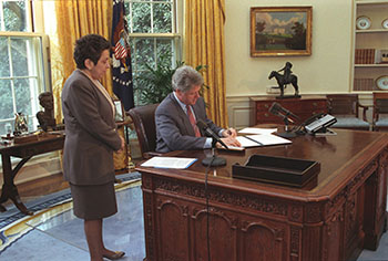 Secretary of Health and Human Services Donna Shalala (pictured observing a 1993 signing with President Clinton) noted, "We need an approach more tailored to the individual needs of each family. An approach that respects the sanctity of the family. An approach that keeps families together." (William J. Clinton Presidential Library)
